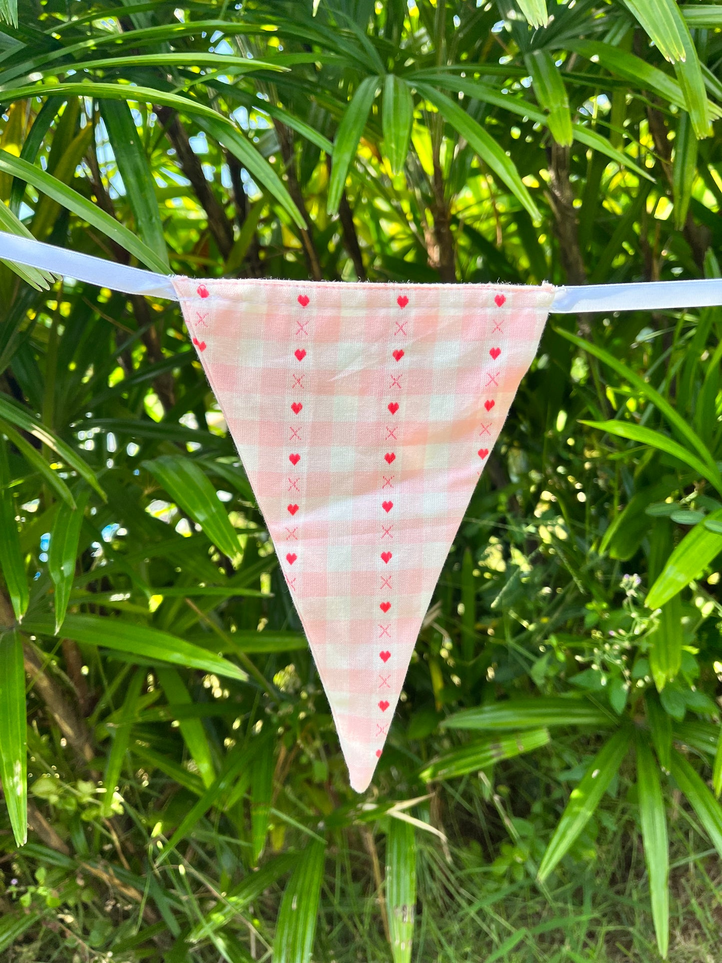 mish pink gingham flag with red embroidered hearts.