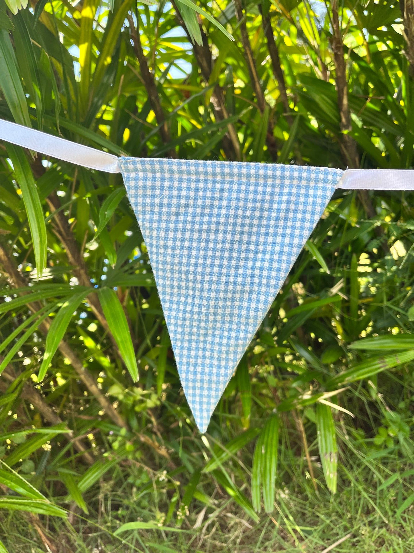 Close up of blue gingham flag on Balloo bunting from Turquaz.