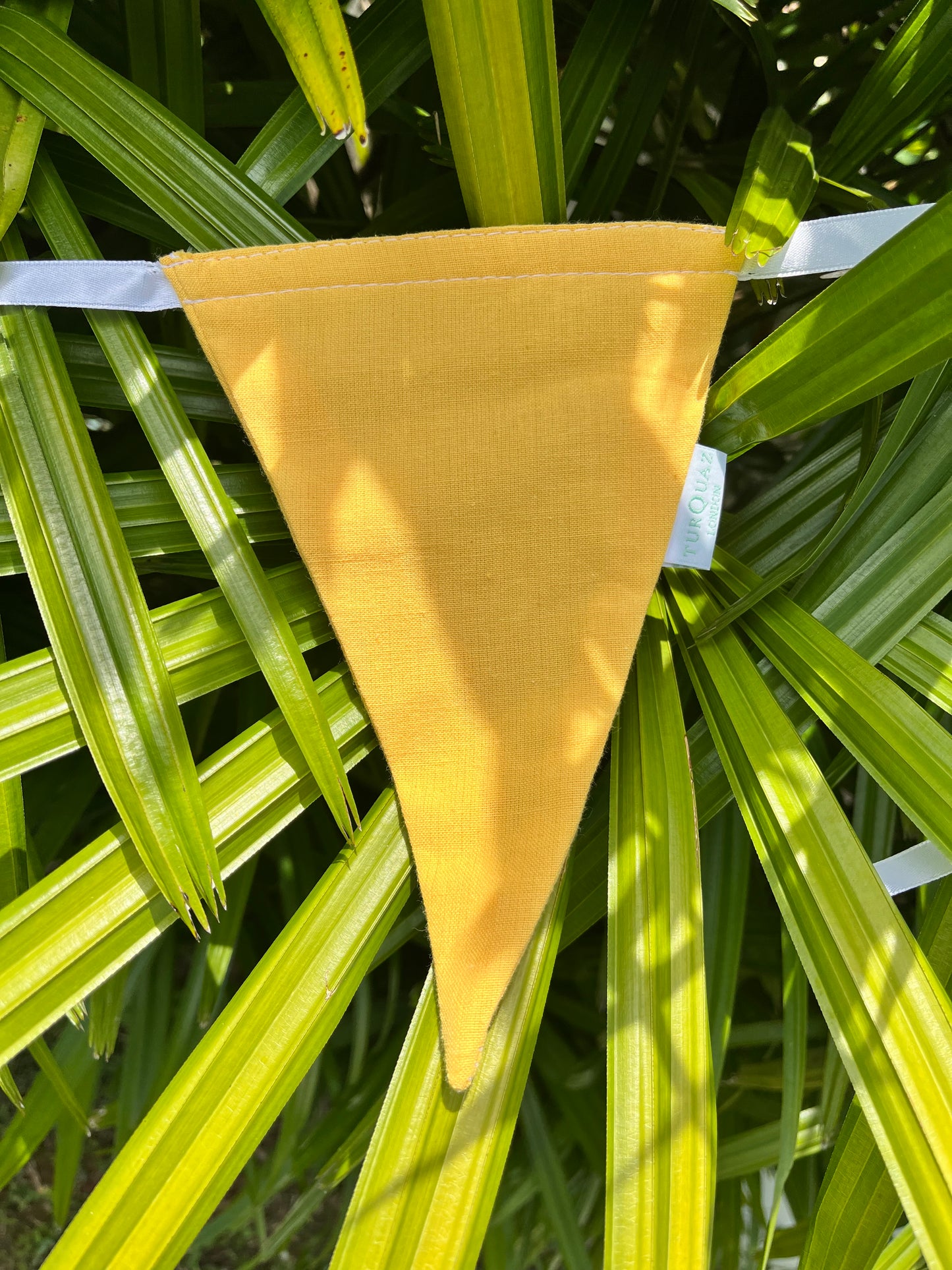 Close up of yellow flag on Balloo bunting from Turquaz.