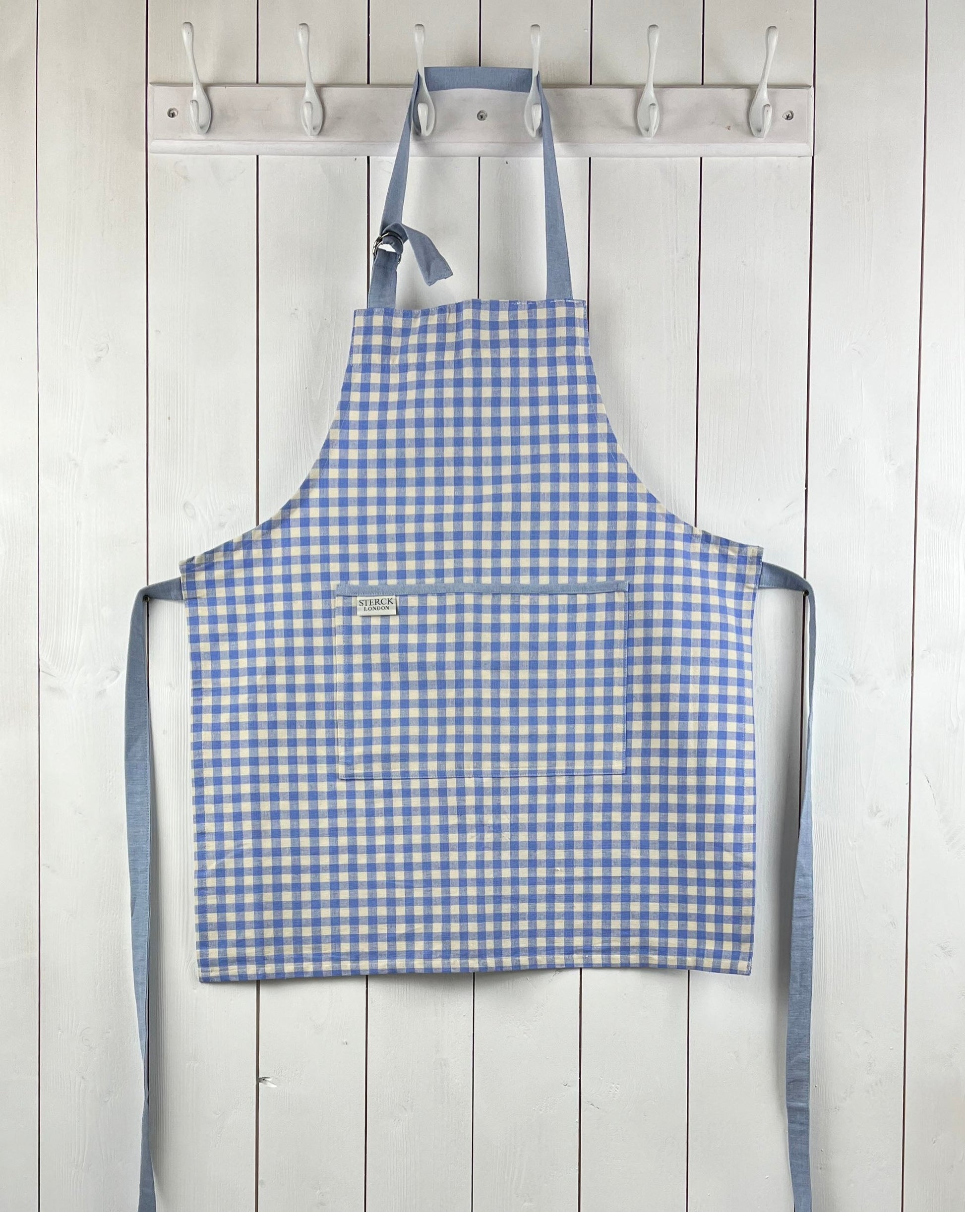 Blue gingham apron for children with large front pocket and adjustable neck strap.  TurQuaz.