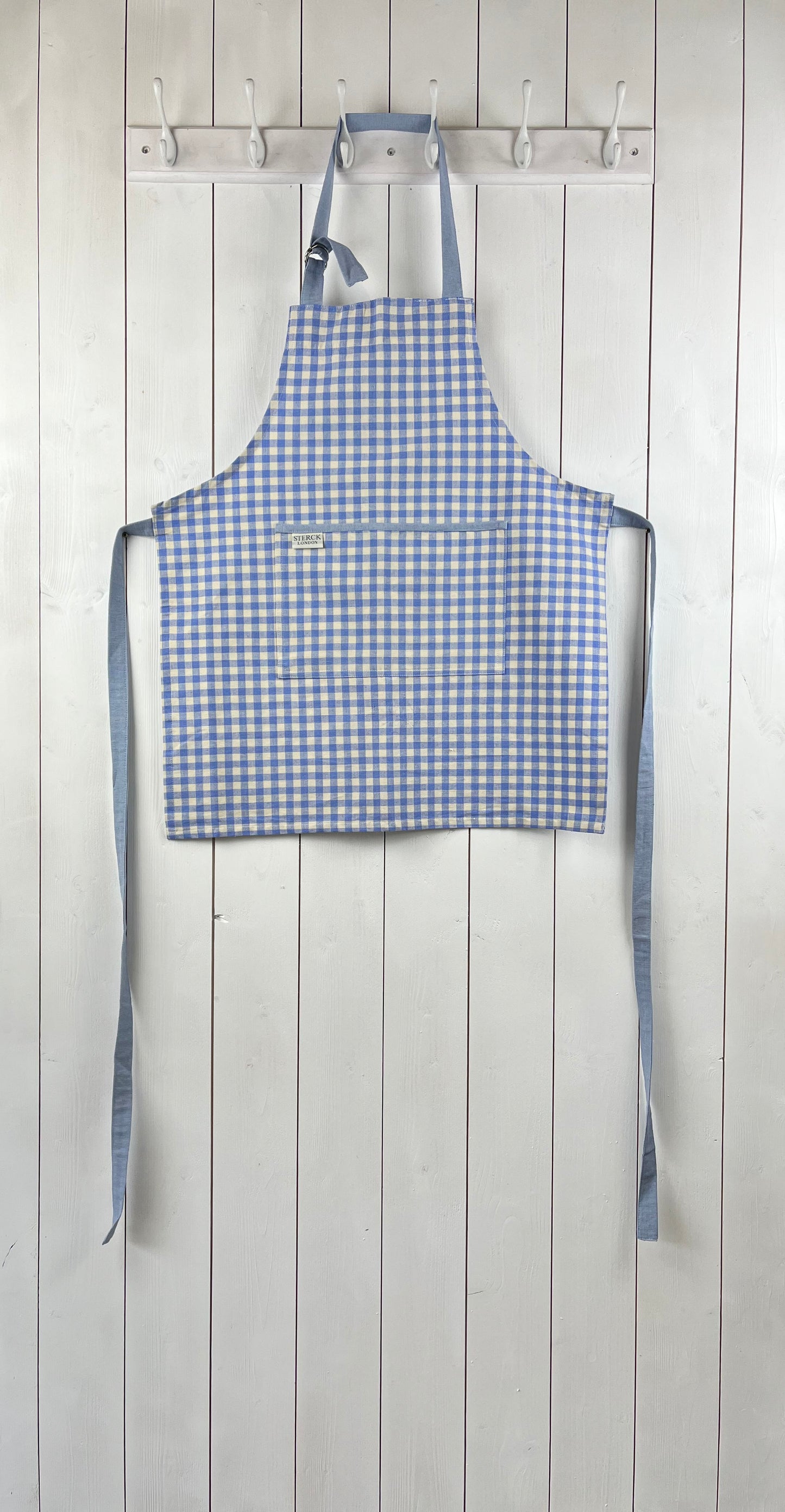 Blue gingham apron for children with large front pocket and adjustable neck strap.  TurQuaz.