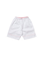 A classic white cropped pyjama with pink gingham edging for children, from Turquaz.