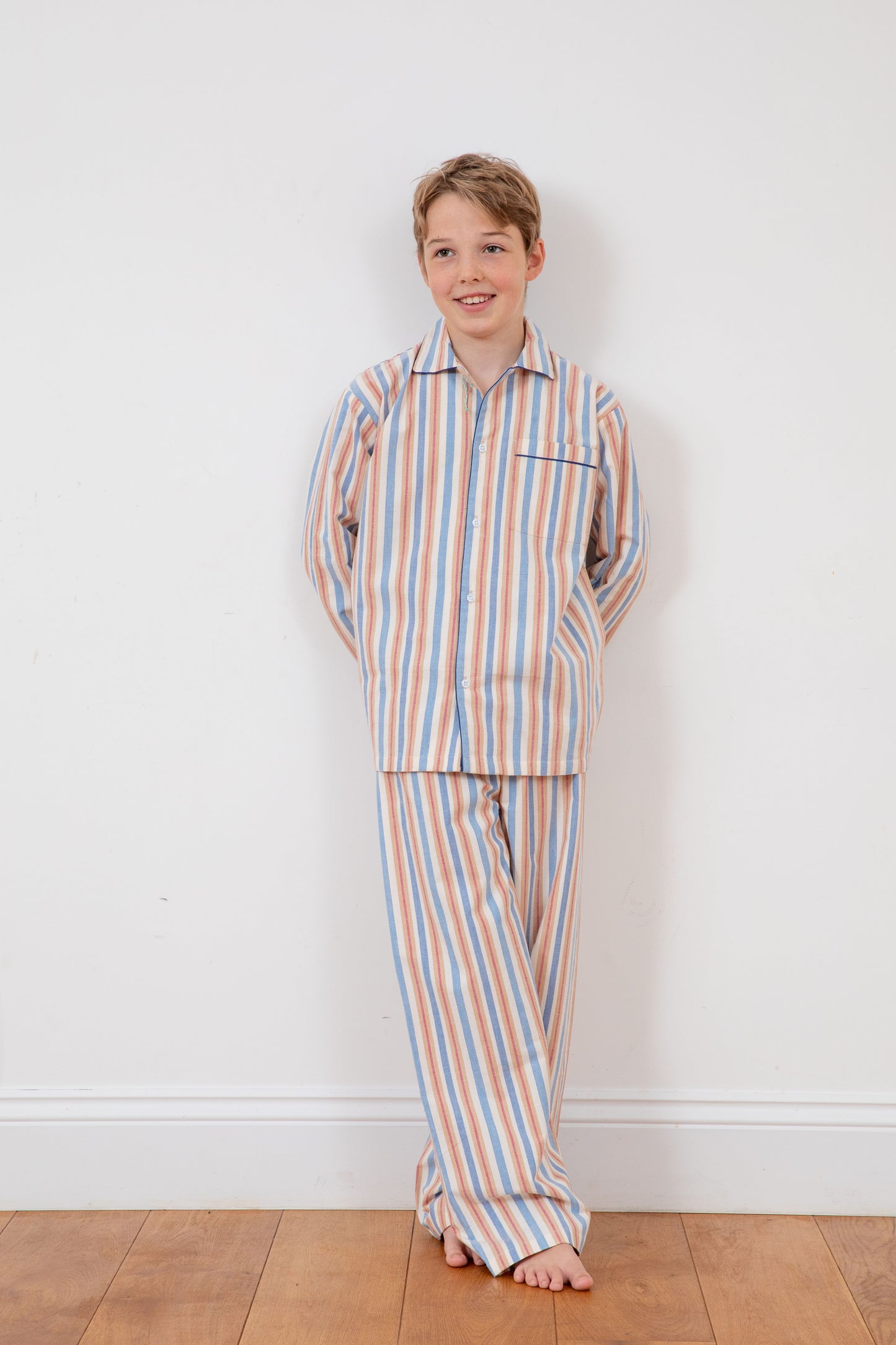 A boy wearing striped natural cotton Toto pyjamas by TurQuaz